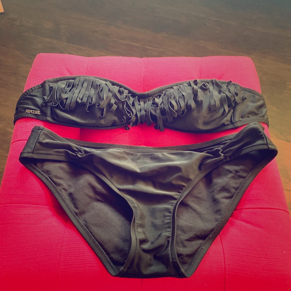 Black bandeau style rip curl bikini with fringe.